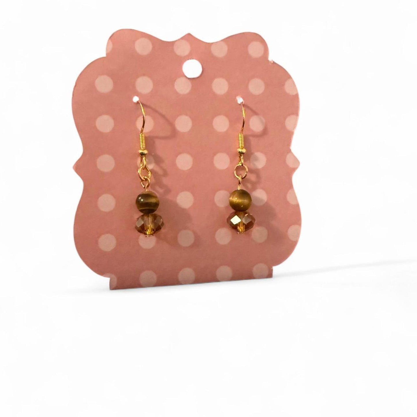 Handmade tigers eye bead and orange glass crystal earrings on a gold toned hook.